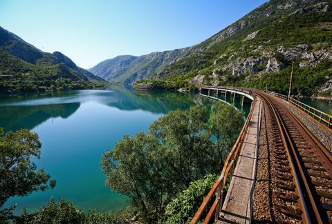 A train running alongside the Neretva river through the canyon on the Sarajevo to Mostar line