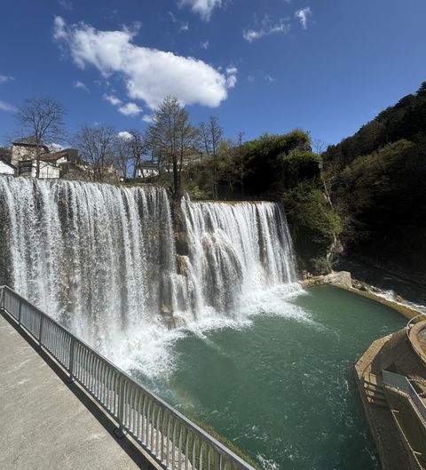 The Jajce waterfall framed by the stone houses and fortress of the old town