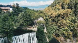 The Pliva waterfall tumbling into the river beneath the old town of Jajce in central Bosnia
